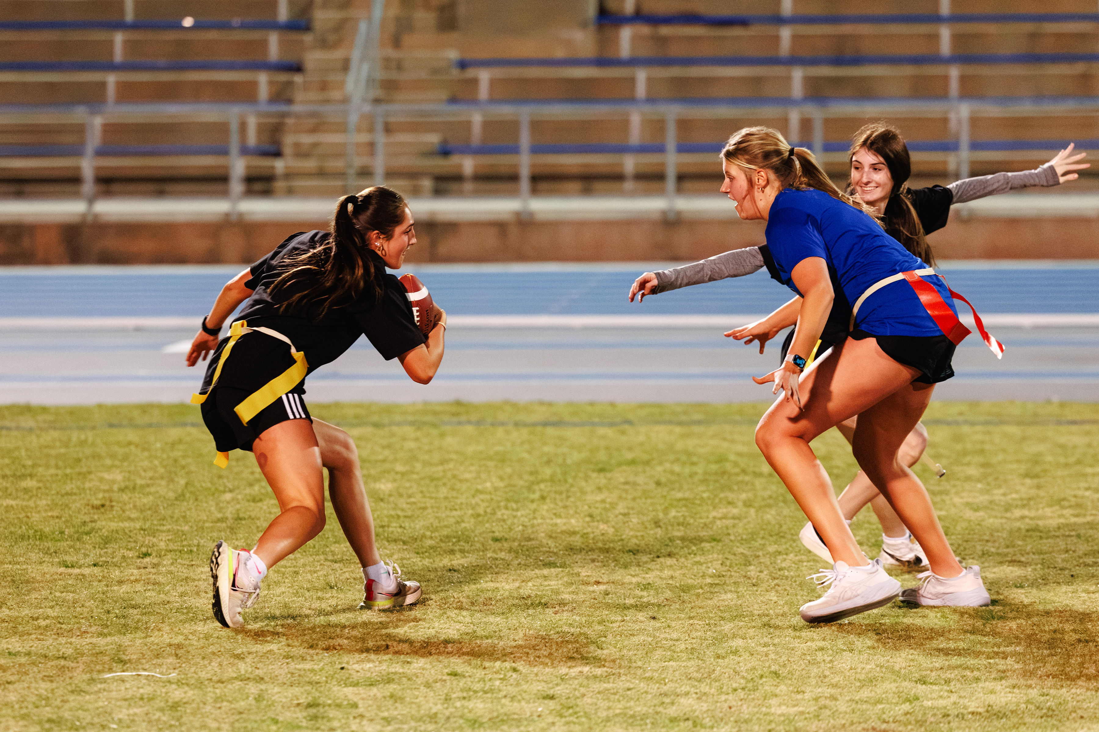 Girl trying to get past a defender with the football
